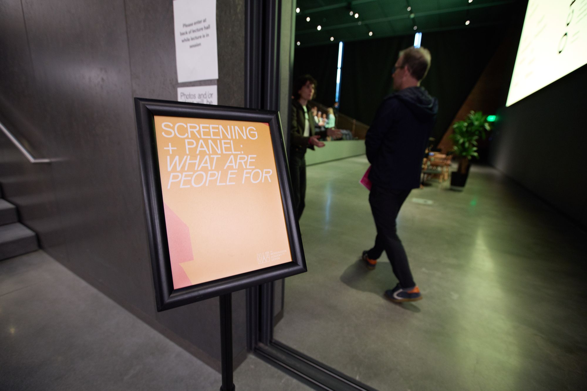 The sign to the door, sharing hte name of the event.